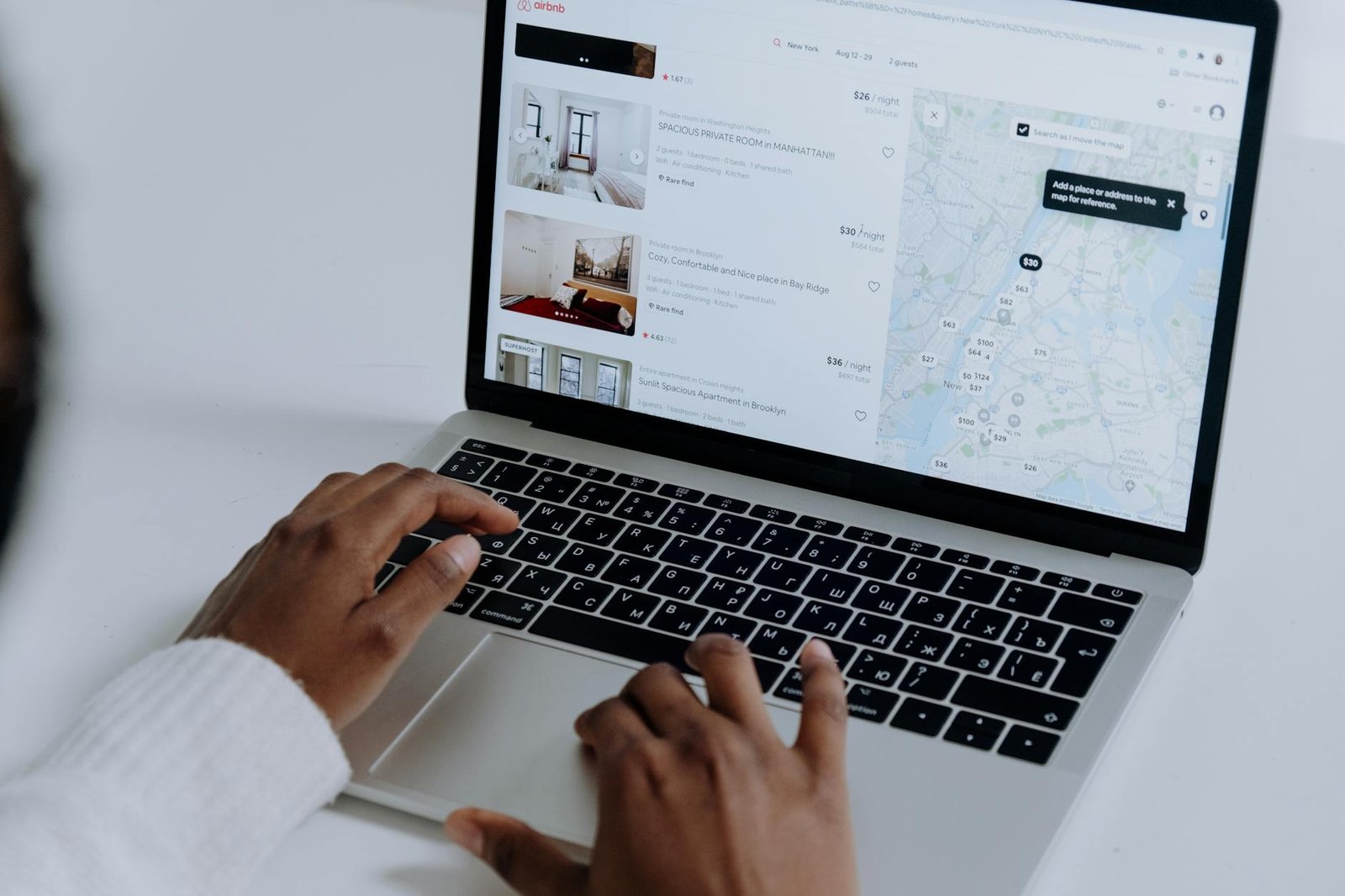 https://www.pexels.com/photo/person-using-macbook-pro-on-white-table-5077049/