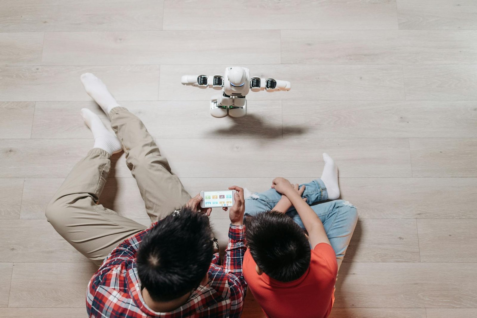 https://www.pexels.com/photo/top-view-shot-of-people-controlling-the-robot-using-a-cellphone-8294821/